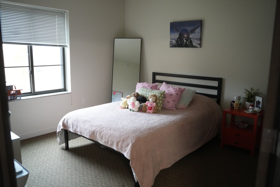 A decorated Western View bedroom with a bed and a large window.