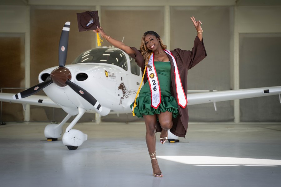 A'maree Waddell jumps in celebration of her graduation.