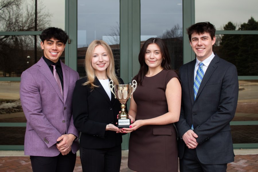 WMU sales students with Desert Cup in front of doors to the College