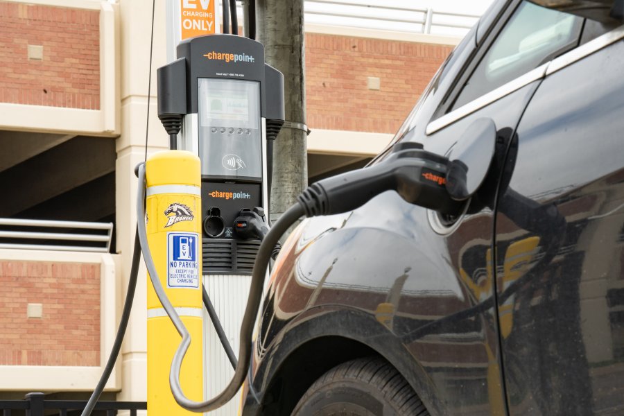 An electric vehicle is charging at a ChargePoint station, located by the Miller auditorium parking ramp.