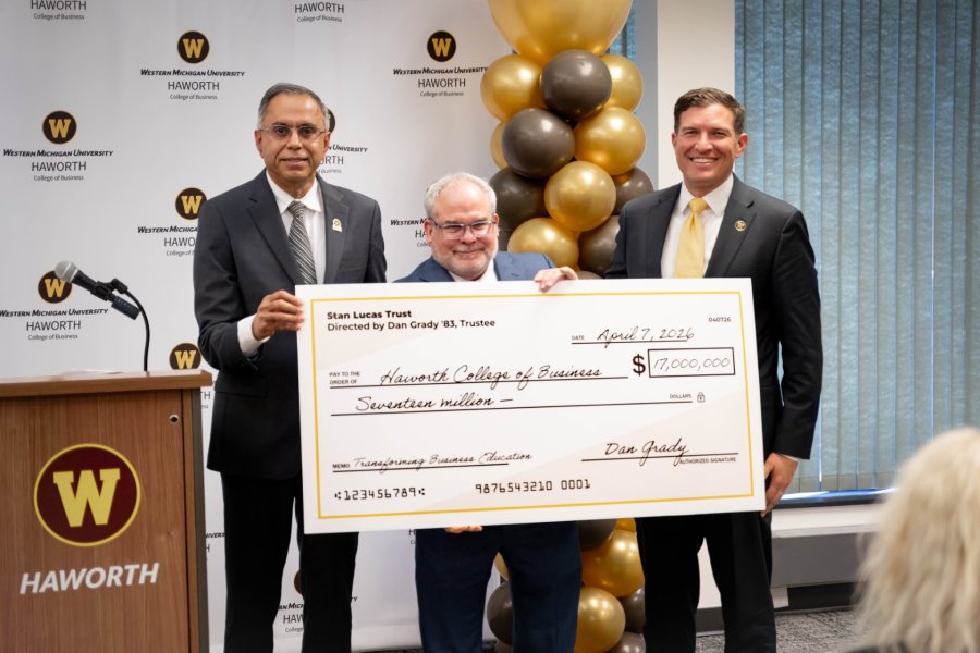 Dan Grady holding a check of $17 million dollars with the WMU president and WMU Haworth Dean