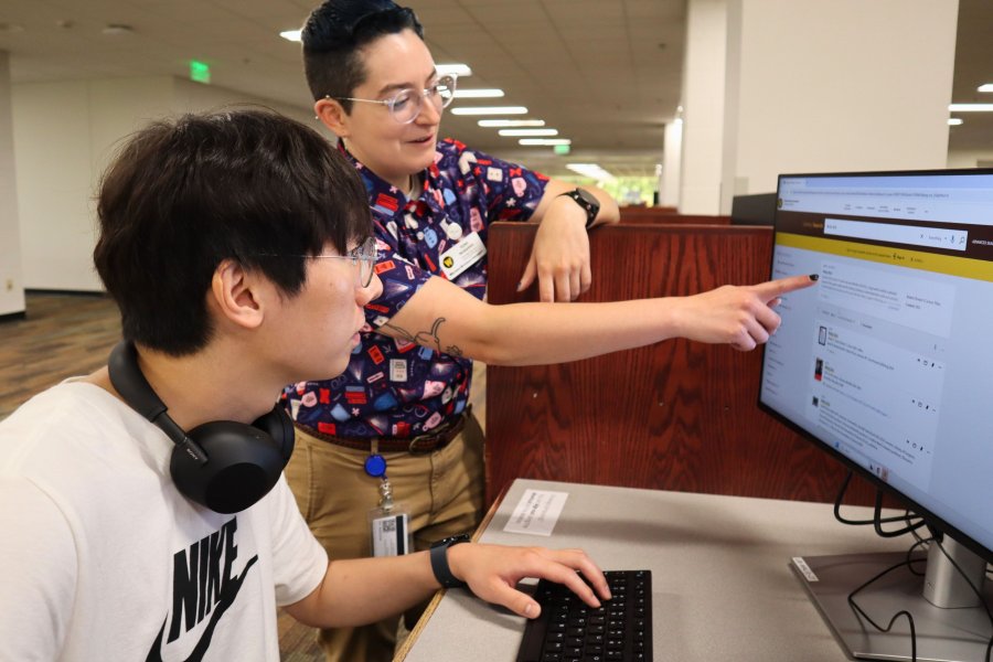 Librarian Dylan McGlothlin showing a student how to use Library Search during a research consultation.