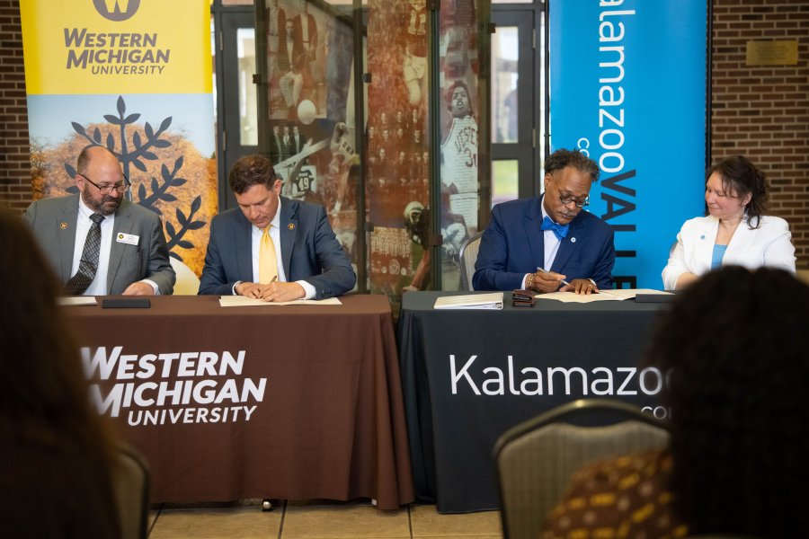 WMU President Russ Kavalhuna and KVCC President Dr. L. Marshall Washington sign documents.