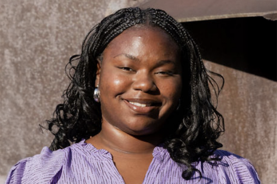 Mariah Mauldin wearing a purple dress and smiling outside