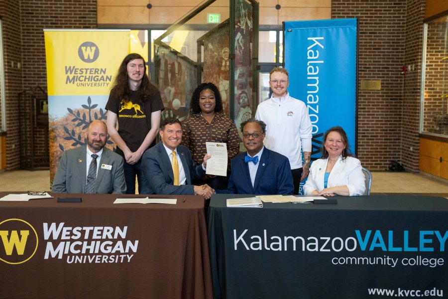 The presidents and provosts of WMU and KVCC sit at a table with students.