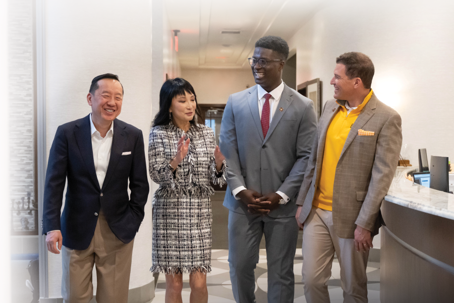 Mo Tall standing with the Zhangs and President Kavalhuna