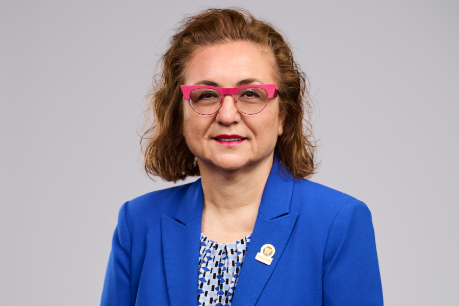 Devrim Yaman wearing a blue blazer and patterned blouse