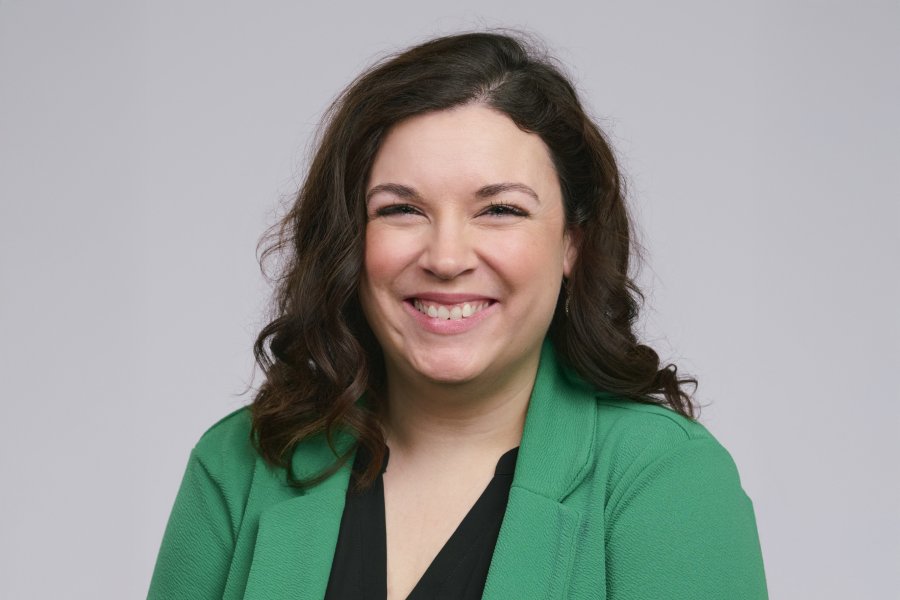 Elizabeth Case wearing a green blazer and black blouse