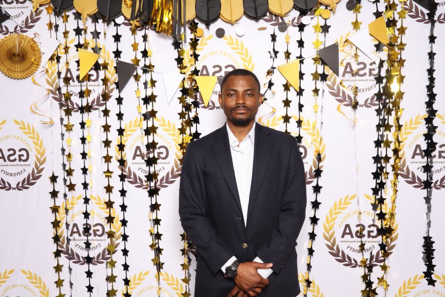 An international student poses on campus at a party.