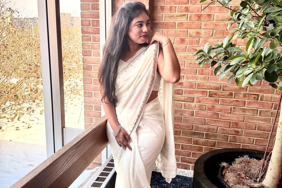 An international student from India poses on campus during graduation season.