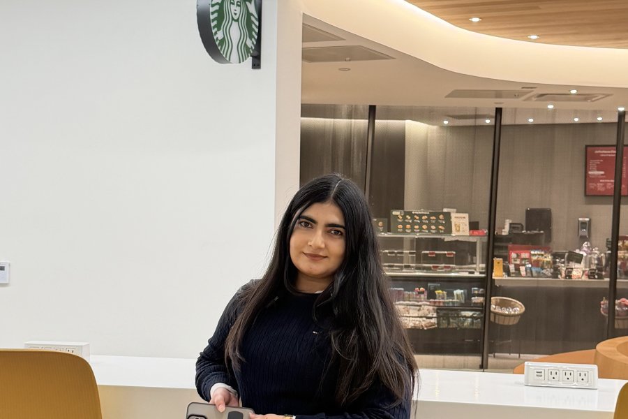 An international student poses near Starbucks in the Student Center.