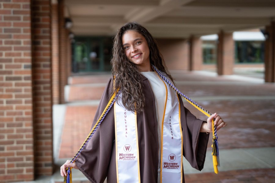 Jadazay Ledbetter celebrates in her graduation regalia.