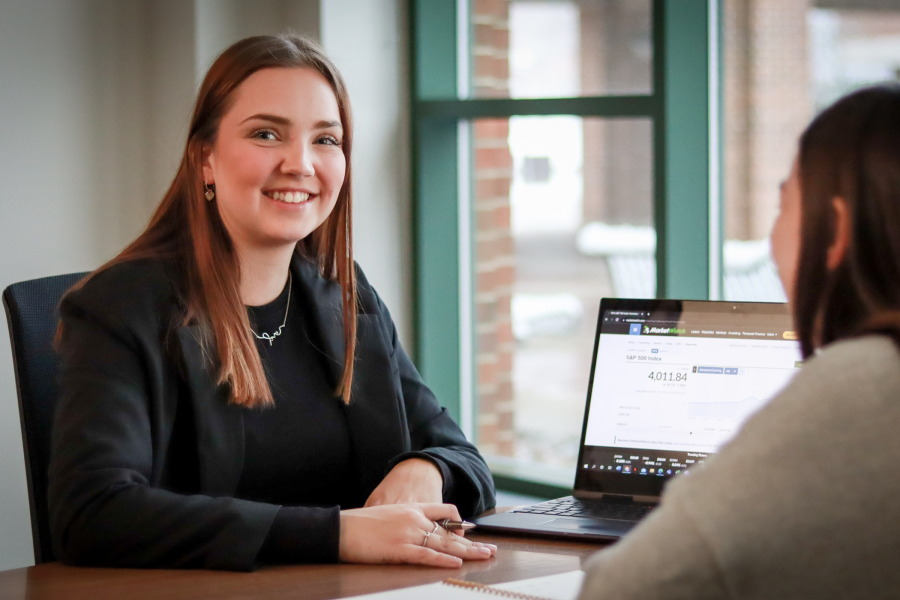 Makenna Grezlik seated at a desk with a laptop