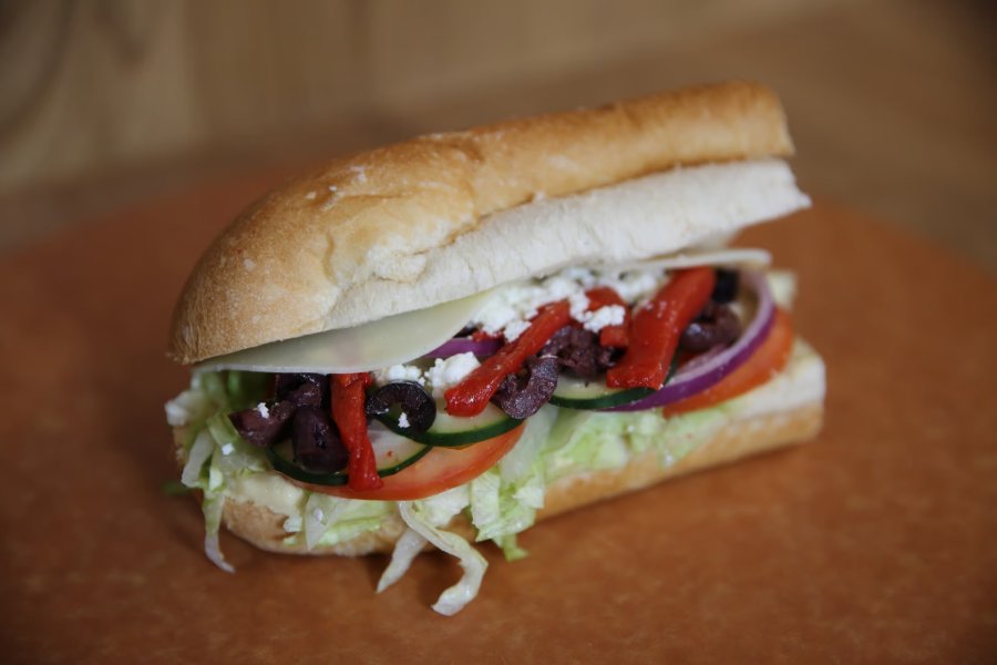 "The Refresh" sandwich displayed on a wooden background.