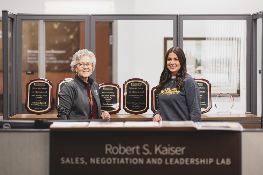 Kelley O'Reilly and Ellen Worobec standing in the Robert S. Kaiser Sales Lab