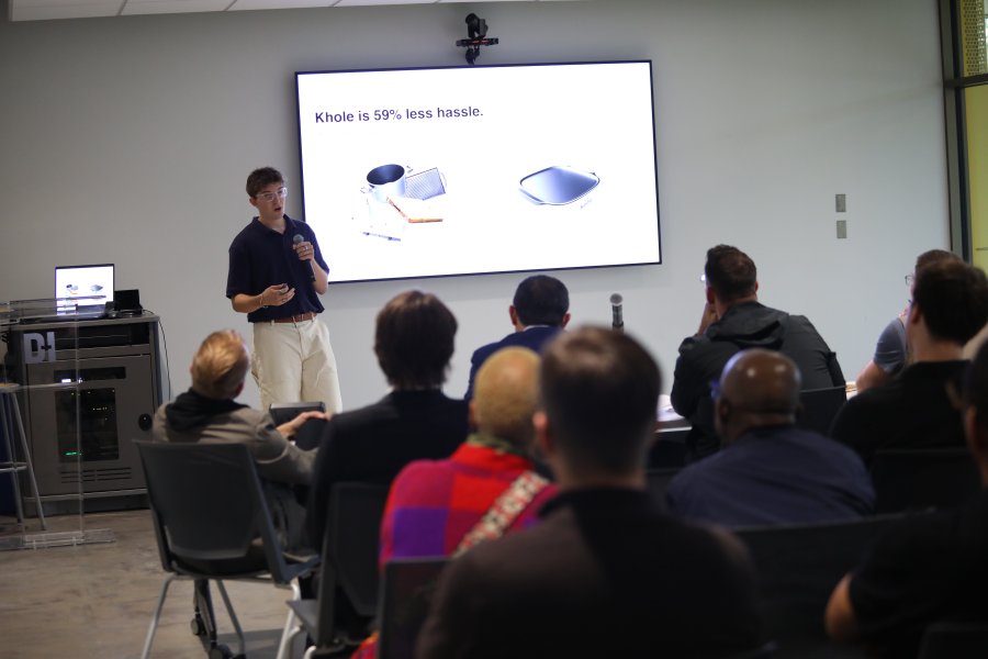 A student presents a product during a pitch competition.