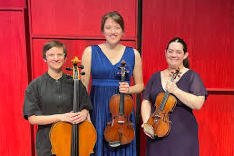 Three women in formal clothing holding a violin, viola, and cello, respectively.