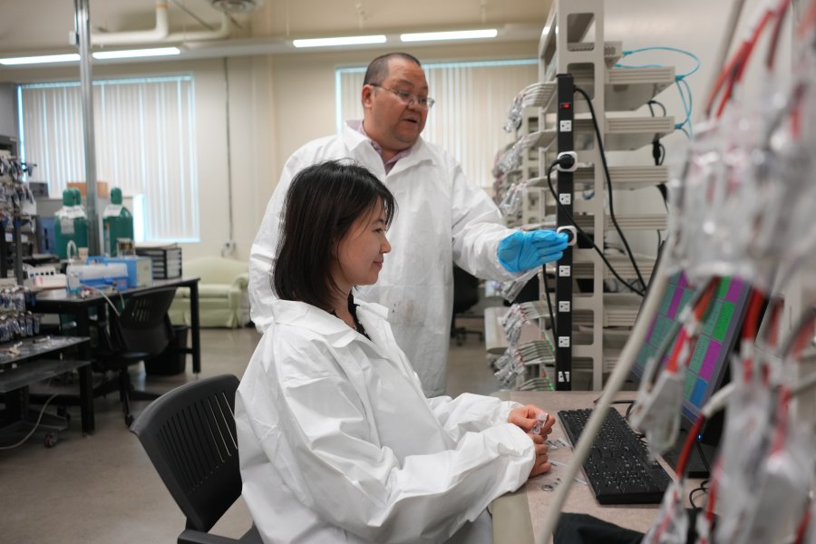 Student and instructor conduct research for the College of Engineering and Applied Sciences.