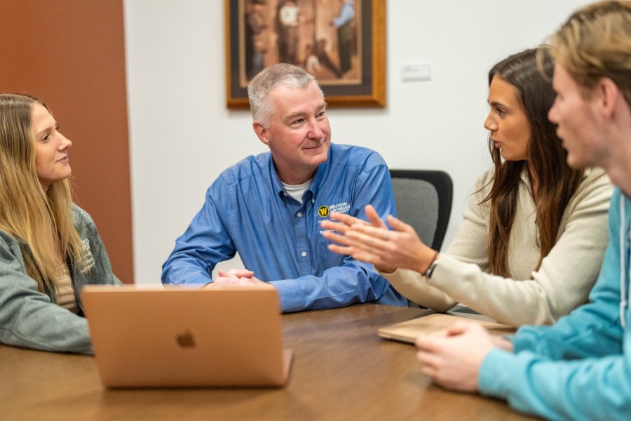 Dr. Jim Eckert with sales students in the Kasier Sales Lab at WMU
