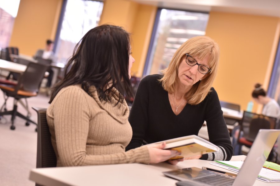 Professor and Student discussing book one on one. 