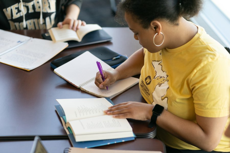 Student writing during creative writing course.