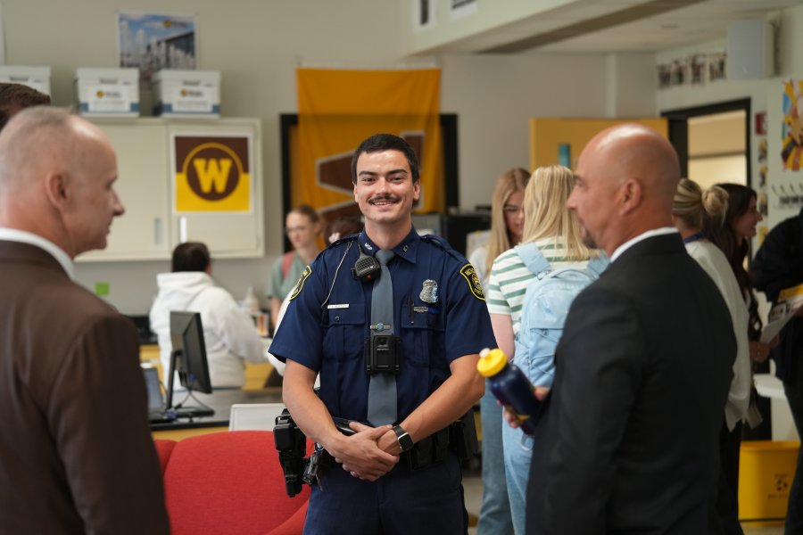 MSP Trooper Sean Montroy smiles in the Cold Case Program space.
