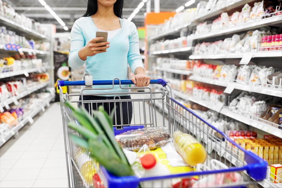Shopper in grocery store deciding what to buy