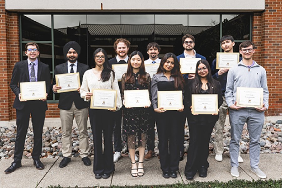 A group of students with their scholarship awards