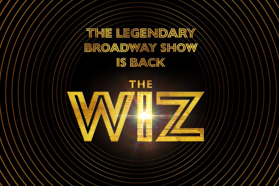 The Wiz show logo in gold font against a black background with a banner reading "The legendary broadway show is back."