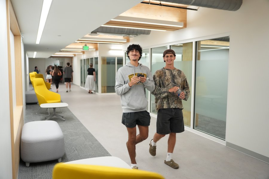 Two students walk the halls of Valley Oaks residence hall.