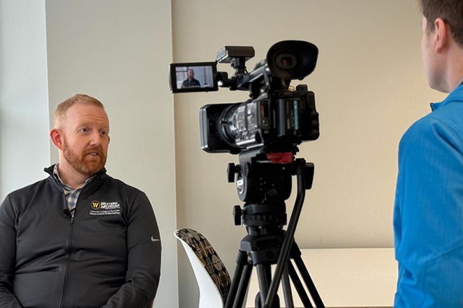 a faculty member, scott cowley, getting interviewed