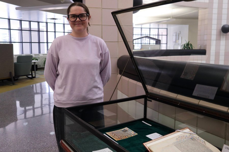 Western Michigan University student Autumn Ropp working on exhibit case about Manuscript Illumination in Flander..