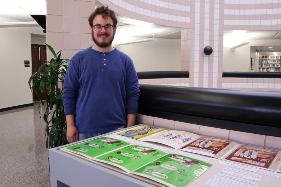 Western Michigan University student Owen Wittbrodt working on exhibit case about The Kalamazoo Vegetable Parchment Company (KVP)..