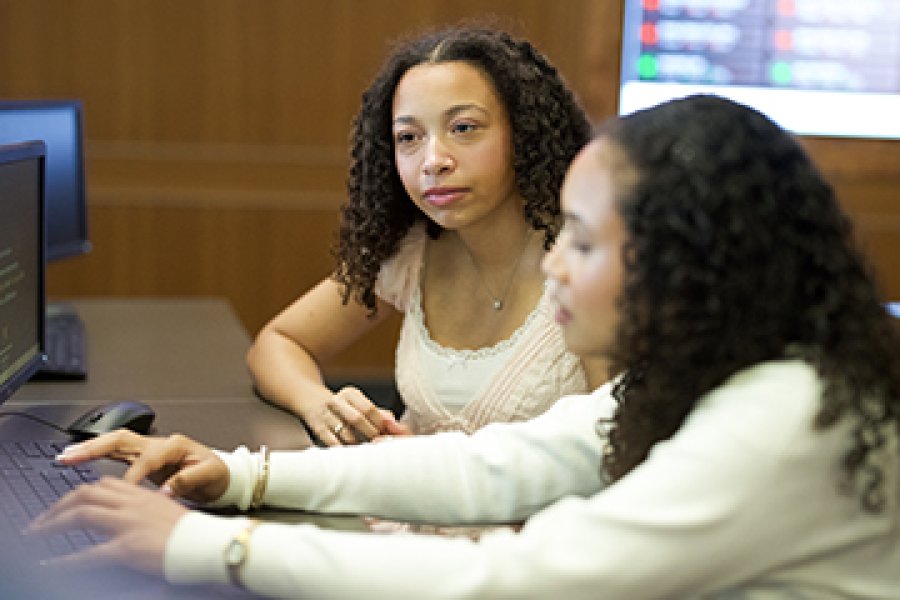 Two students in front of a computer