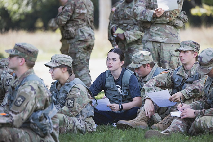 A group of students in the grass at training camp