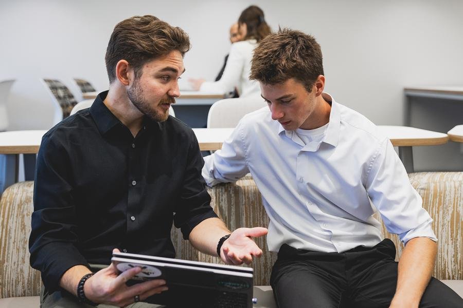 Two students discussing things on a computer