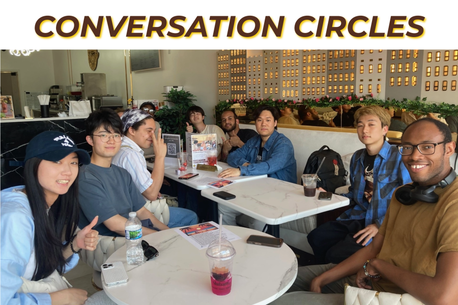 International students practice English downtown. They smile and pose for the camera.