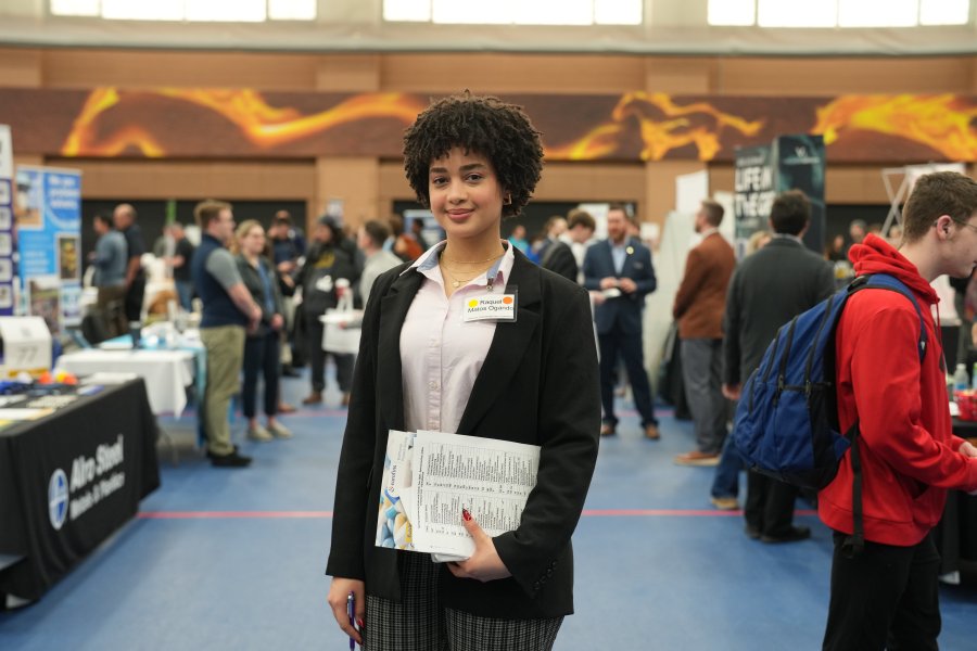 A student with their resume in business attire. 