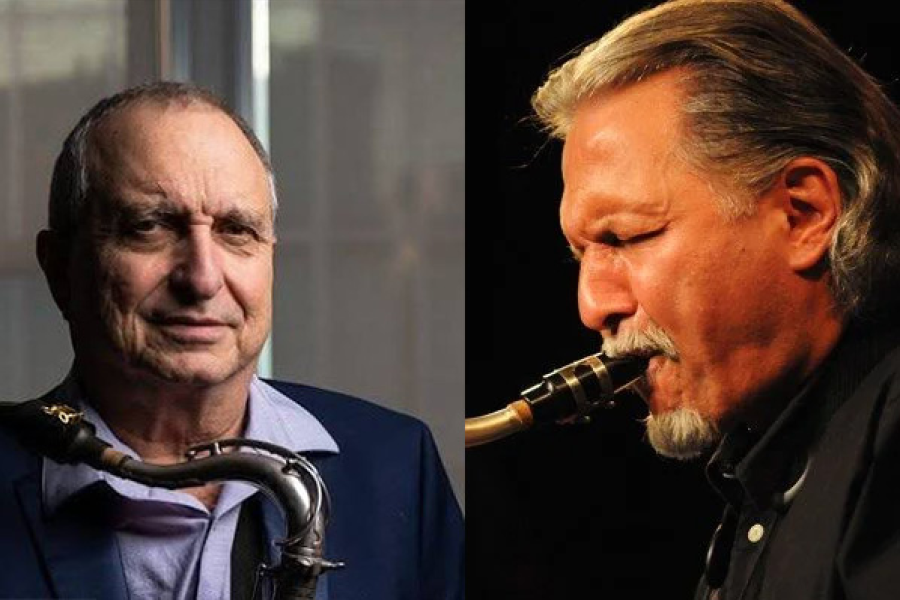 Two men in dark suits holding tenor saxophones.