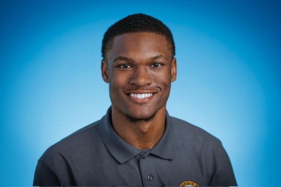 Student Success Coach Josiah with blue background.