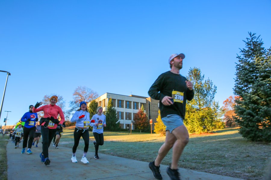 A group of runners jog on Western's campus during the Turkey Trot 5K.