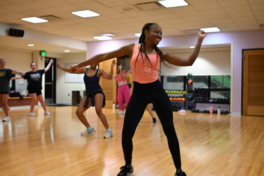 Dance instructor taking src patrons through a workout class