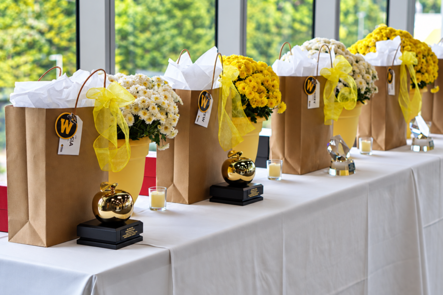 Table with College of Education and Human Development awards and flowers