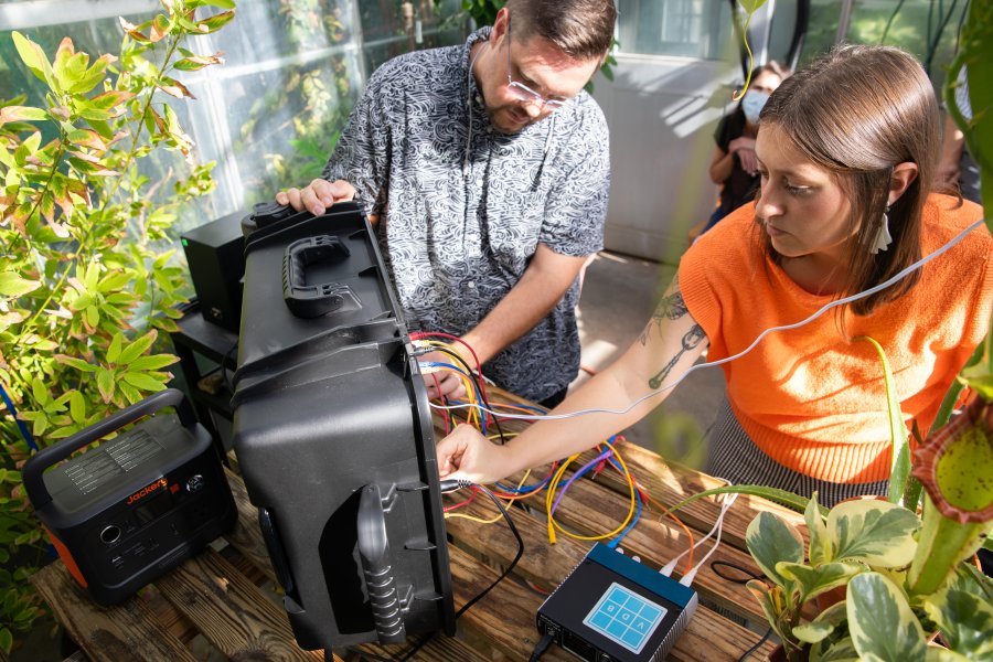 WMU Student and professor engaging with technology 