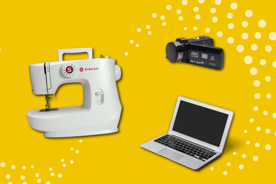 Sewing machine, video camera and laptop on gold background.