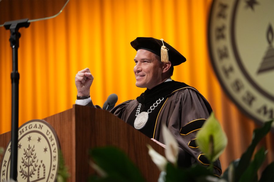 President Kavalhuna speaking at the podium at commencement