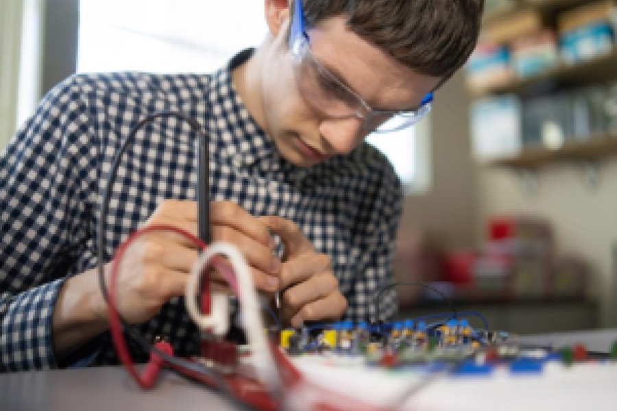 engineering student working on an electrical panel 