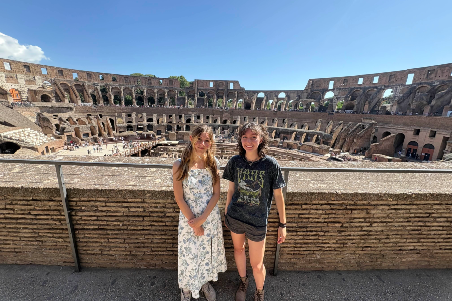 WMU study abroad students stand and smile for a picture inside the coliseum in Rome. 