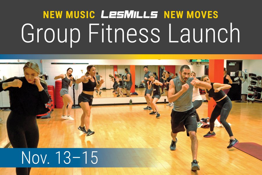 A group of individuals in the group fitness class facing a wall of mirrors.