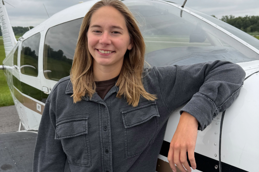 Student in front of plane.